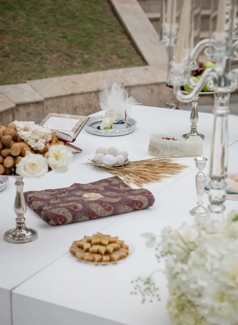 The sofreh aghd, the Persian ceremony table, with silver candelabra, sweets and white flowers