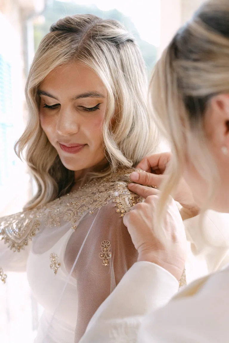 Ashton with glam waves as her grandmother's embroidered cape is placed on her