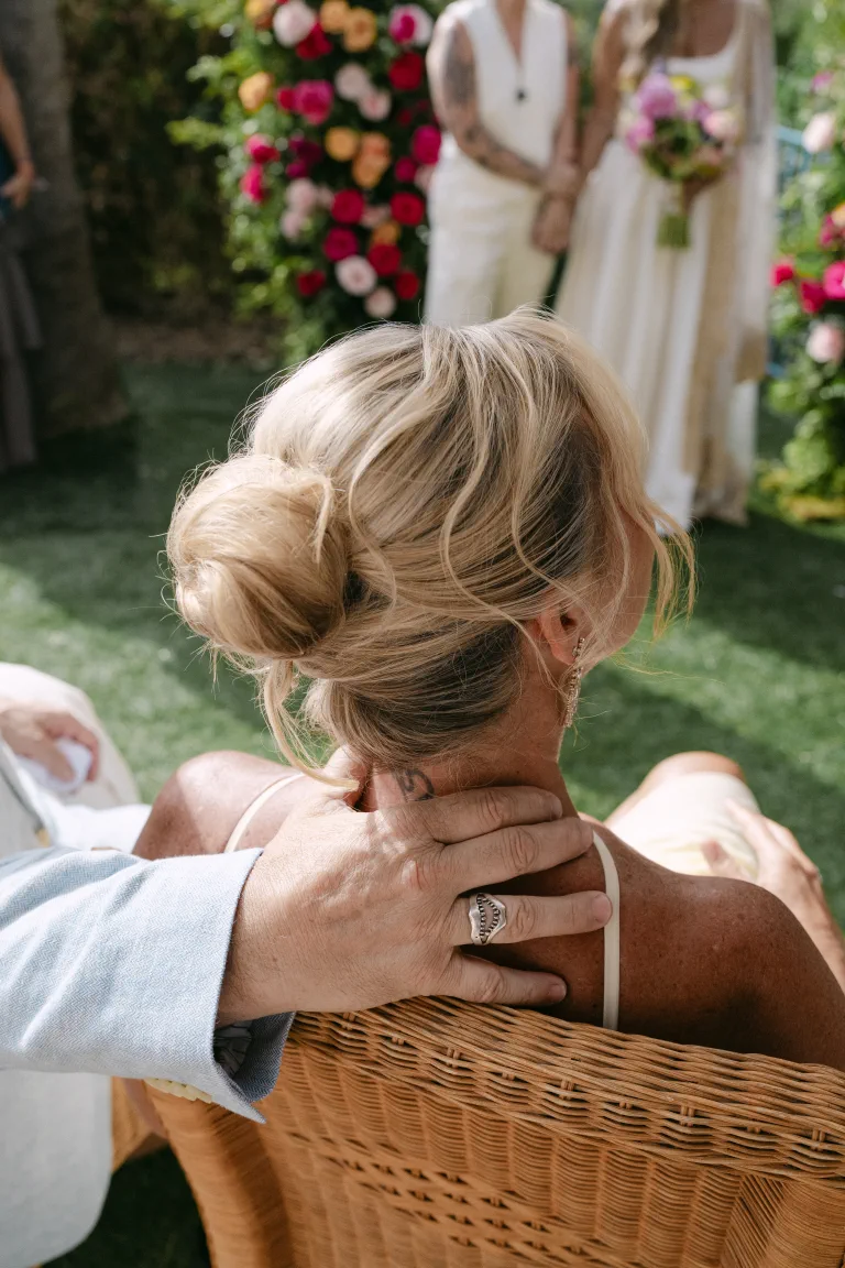 Jordan's mother's updo seen from behind, in the garden among flowers