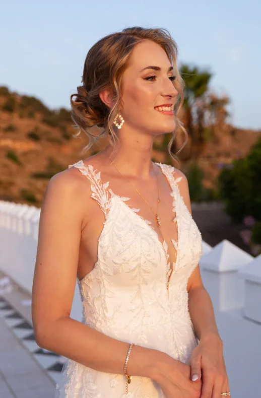 Portrait of the bride at sunset at Fort Inglés, Mijas, with a romantic updo and golden-toned makeup