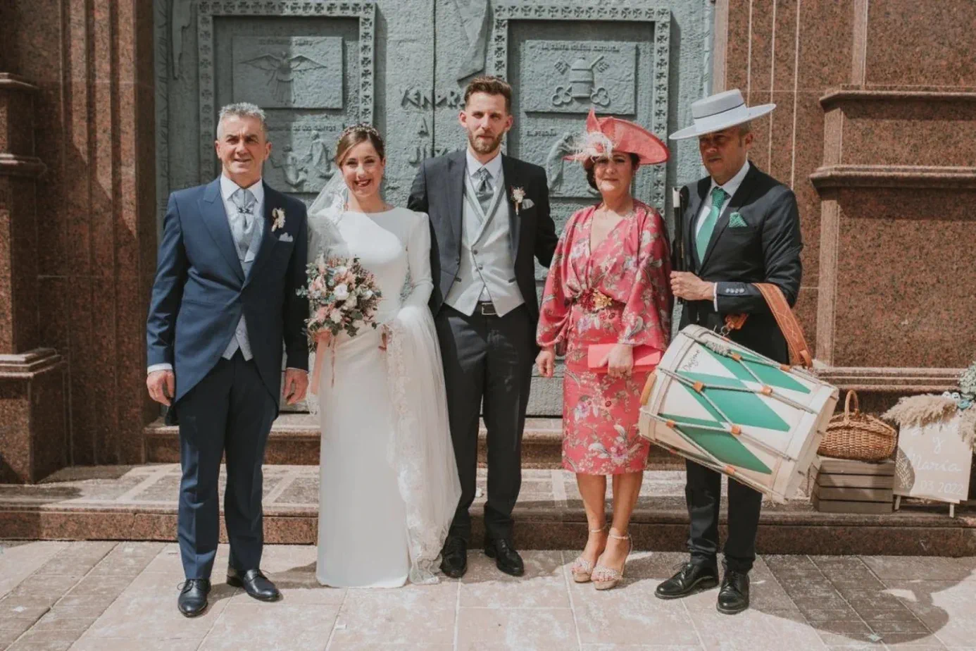The bride and groom with their family at the door of the church of El Rosario, Fuengirola