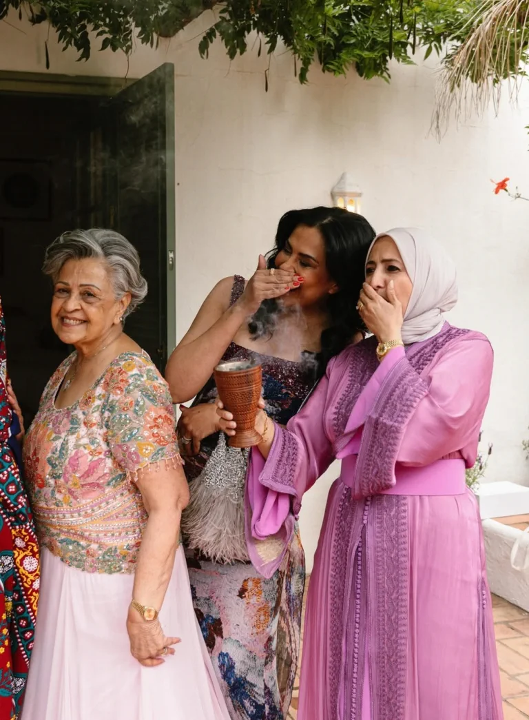 Hanadi's grandmother, with her classic blow-dry, laughs with other women of the family