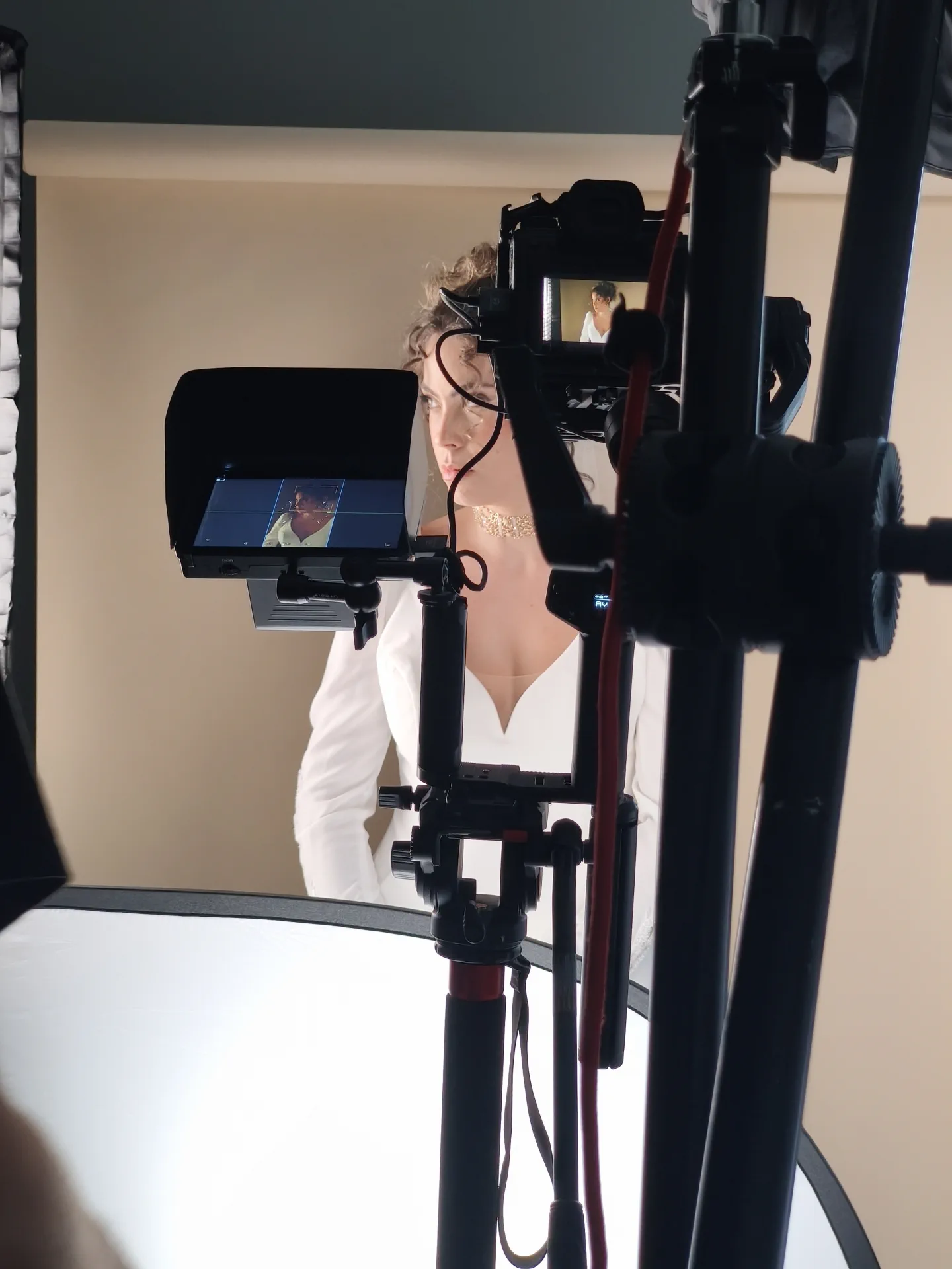 The camera and monitor frame the model in her wedding dress